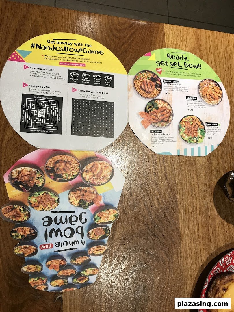 A Nando's promotional menu featuring customizable PERi-PERi bowls and a fun 'Bowl Game'.