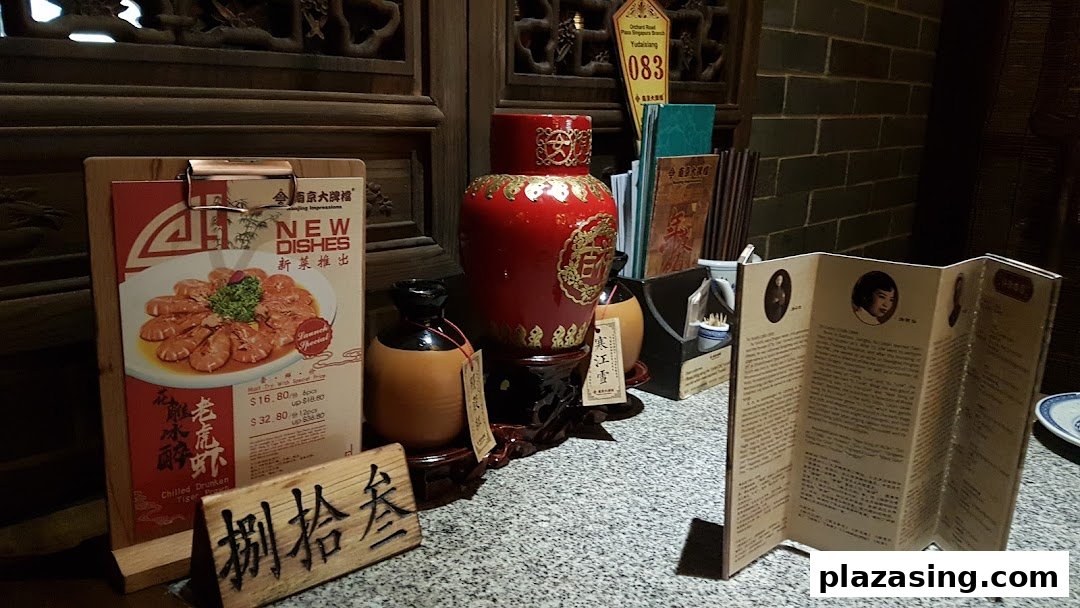 A promotional display featuring 'New Dishes' and prices for Chilled Drunken Tiger Prawn at Nanjing Impressions.
