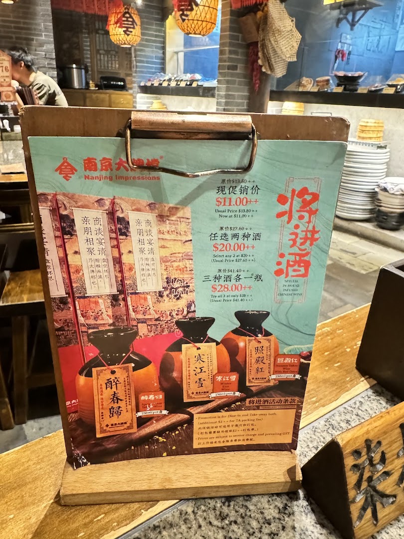 A menu board showcasing special offers on traditional Chinese infused wines inside a restaurant.