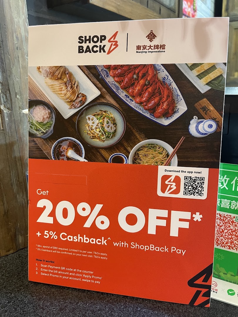 Promotional stand for Nanjing Impressions, showcasing Chinese dishes and a ShopBack discount offer.