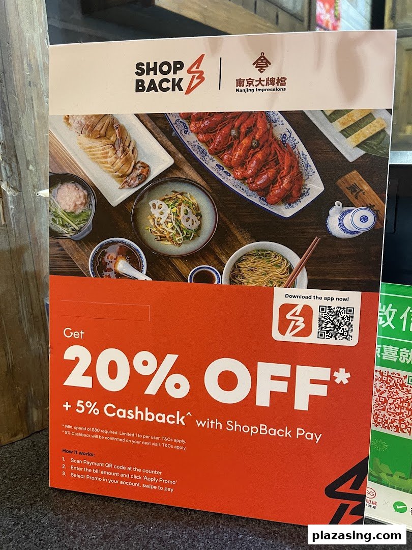 Promotional stand for Nanjing Impressions, showcasing Chinese dishes and a ShopBack discount offer.