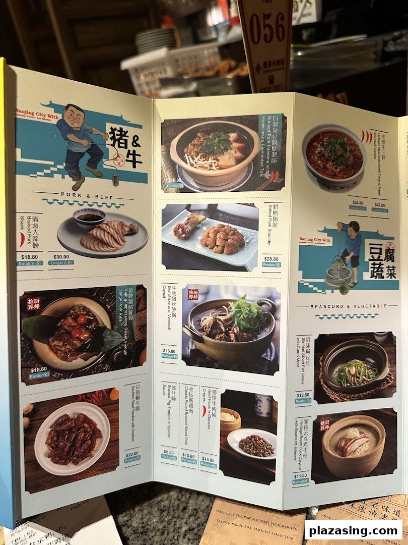 An open menu from Nanjing Impressions 南京大牌档, showcasing various traditional Chinese dishes with prices.