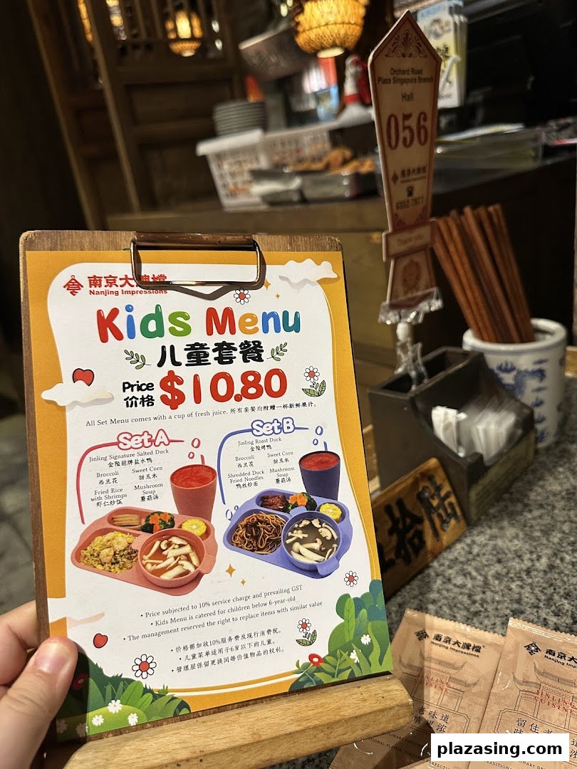 A vibrant kids' menu from Nanjing Impressions, featuring two set meal options with drinks.