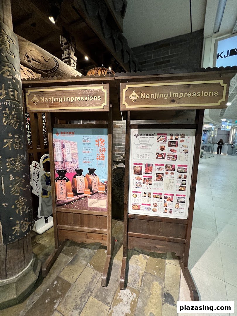 Two wooden display stands showcasing promotions and a food menu for Nanjing Impressions.