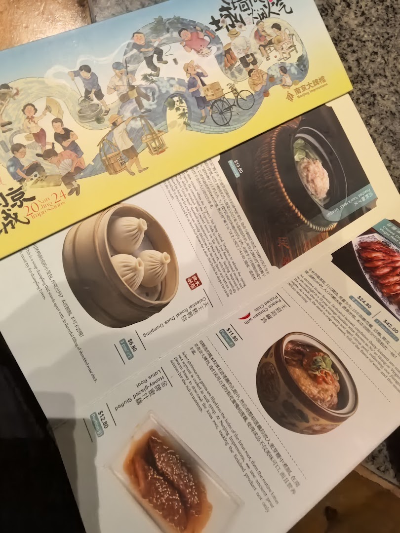 An open menu from Nanjing Impressions, showcasing various authentic Chinese dishes and prices.