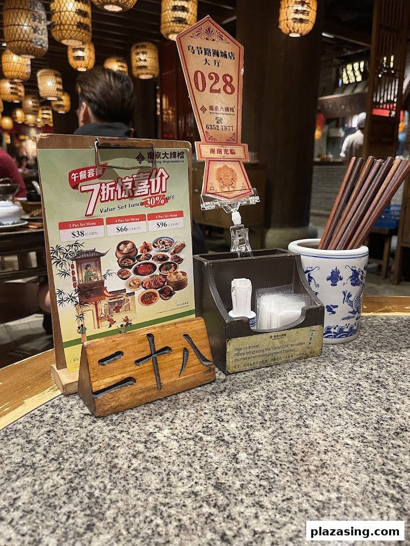 A table setting at Nanjing Impressions featuring a lunch set menu, table number, and chopsticks.