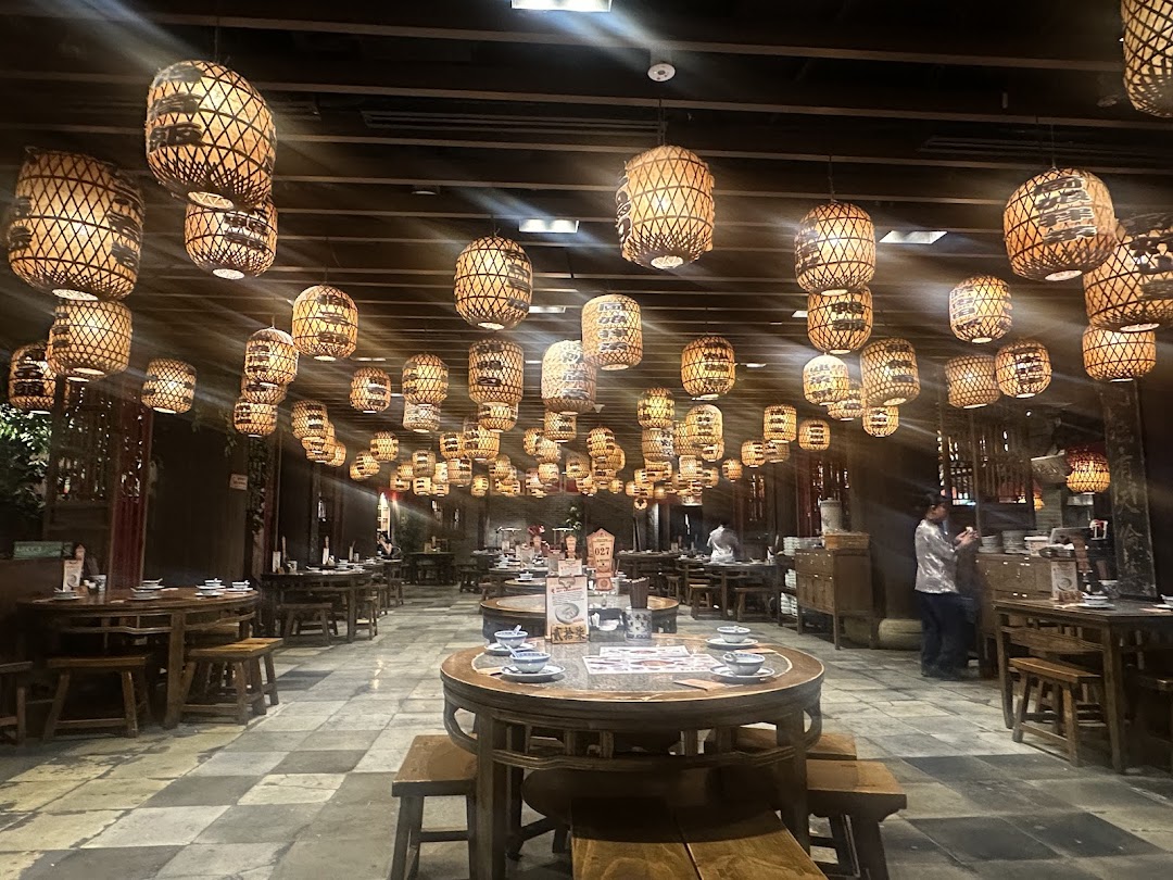 An inviting interior of a restaurant featuring numerous traditional lanterns and wooden tables.