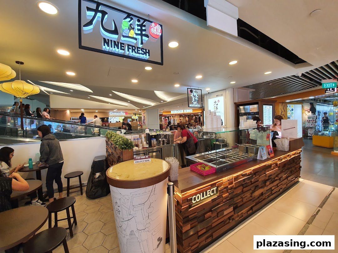 An interior view of Nine Fresh Desserts Taiwan, showing the counter, seating area, and staff.