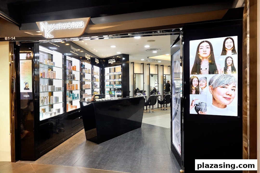 View of NK Hairworks salon entrance with product displays and styling stations.