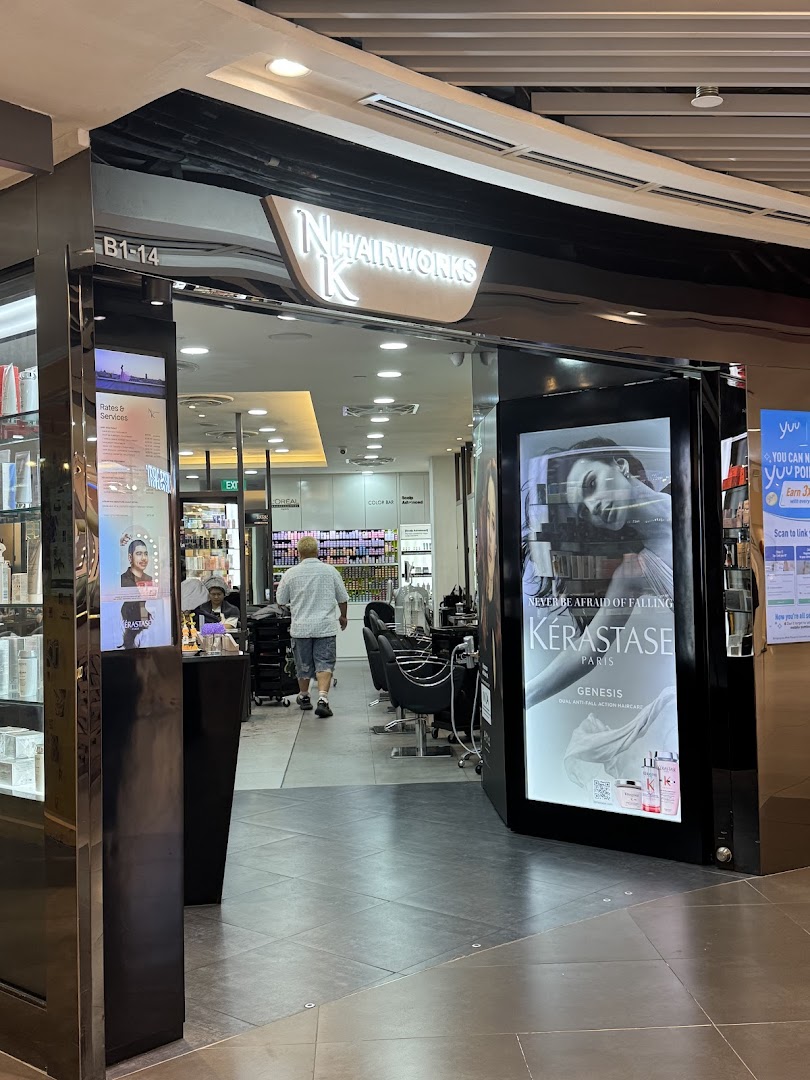 The entrance of NK Hairworks salon with a bright sign and visible interior styling stations.