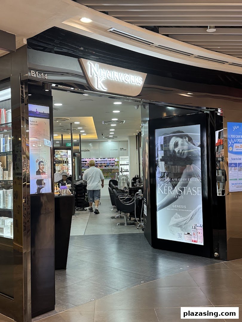 The entrance of NK Hairworks salon with a bright sign and visible interior styling stations.