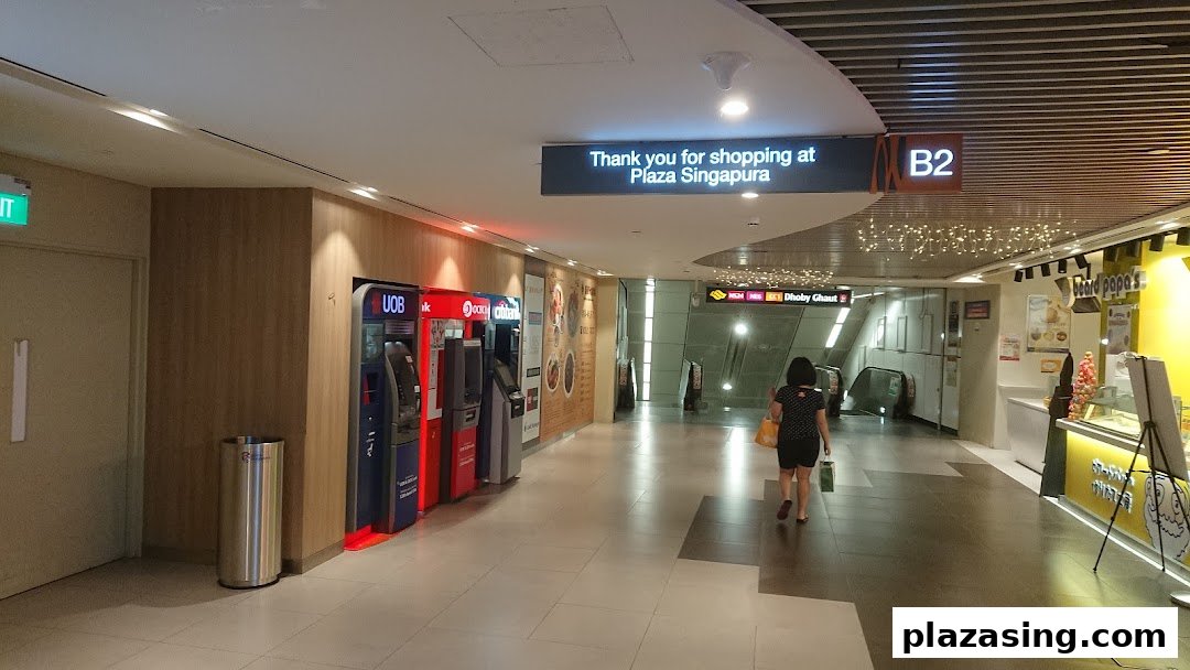 A row of OCBC, UOB, and Citibank ATMs located in a shopping mall corridor.