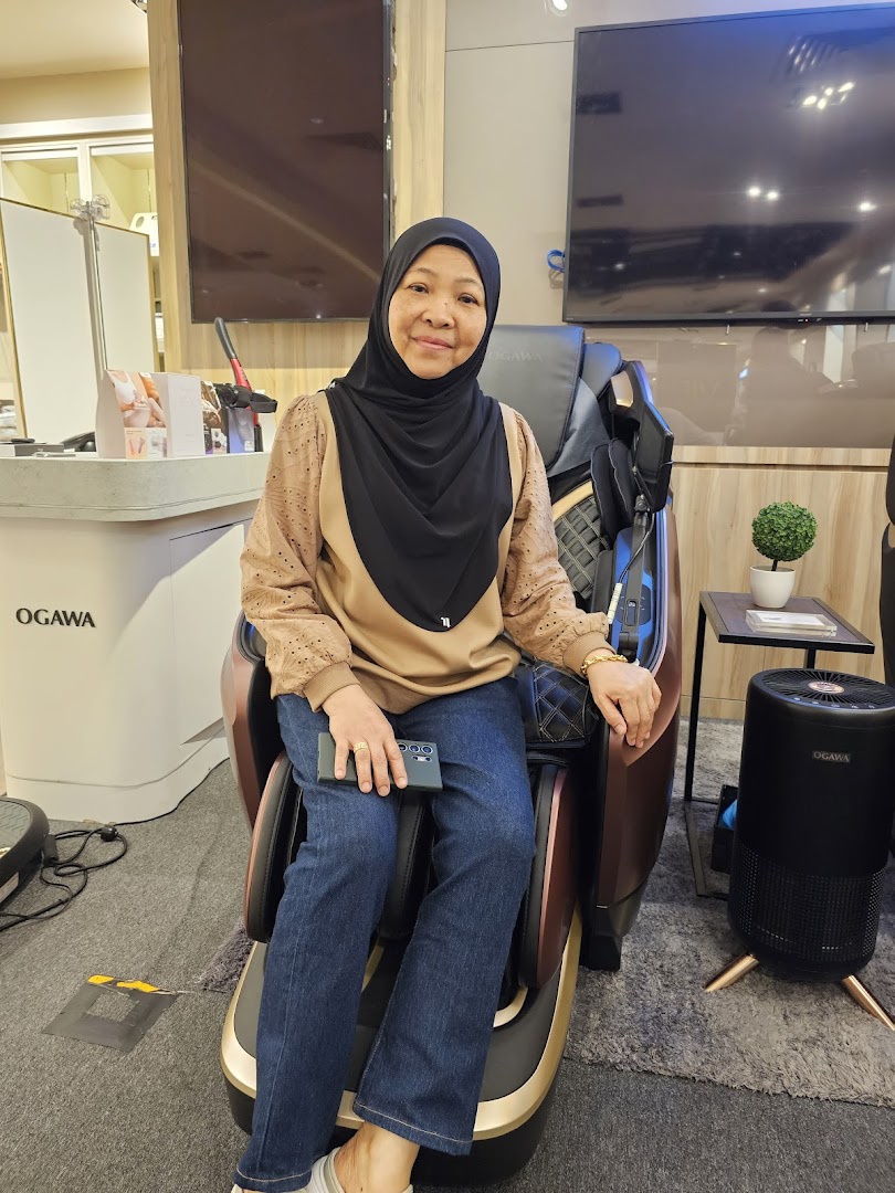 A woman relaxing in a luxurious massage chair at OGAWA Plaza Singapura.