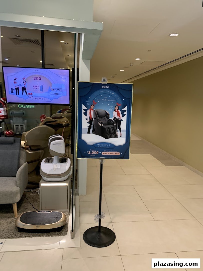 The OGAWA shop front features a display of wellness products and promotional signage for massage chairs.