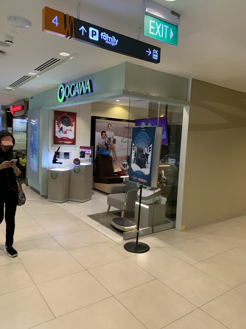 The OGAWA shop entrance in a mall, showcasing wellness products and massage chairs through its glass facade.