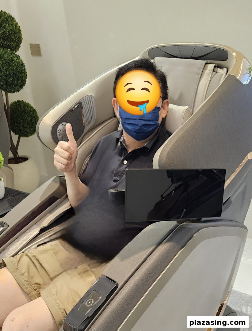 A man comfortably seated in a modern OGAWA massage chair, giving a thumbs-up.
