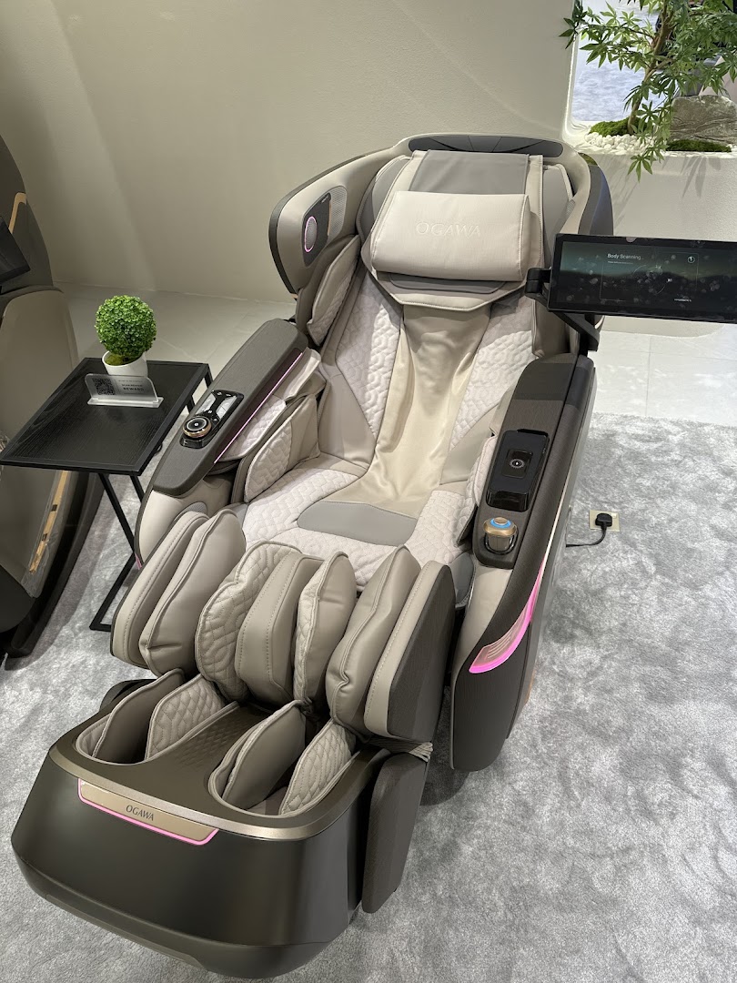 A luxurious OGAWA massage chair with a sleek design and integrated tablet display.