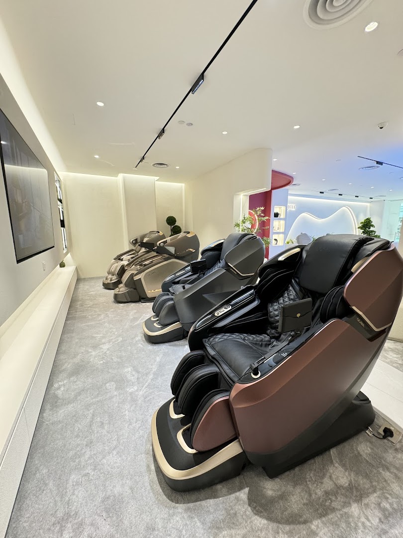Interior view of OGAWA shop showcasing several luxury massage chairs in a modern setting.