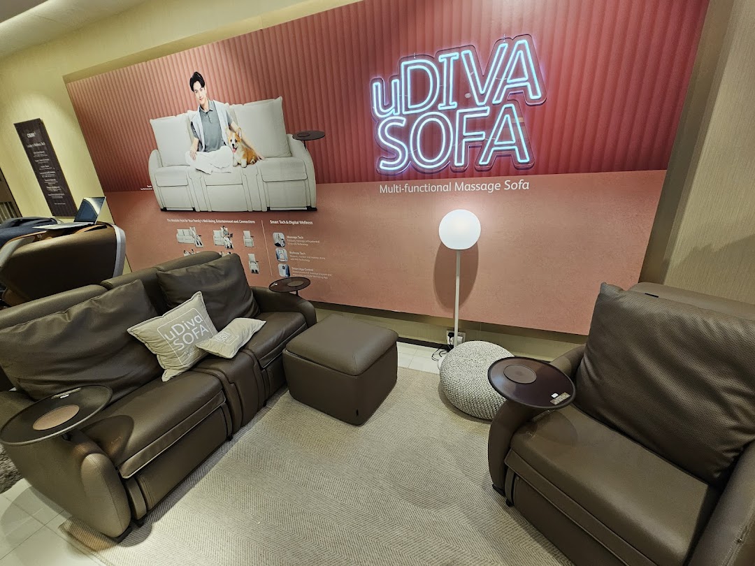 OSIM store interior showcasing brown uDiva massage sofas and a large promotional display.