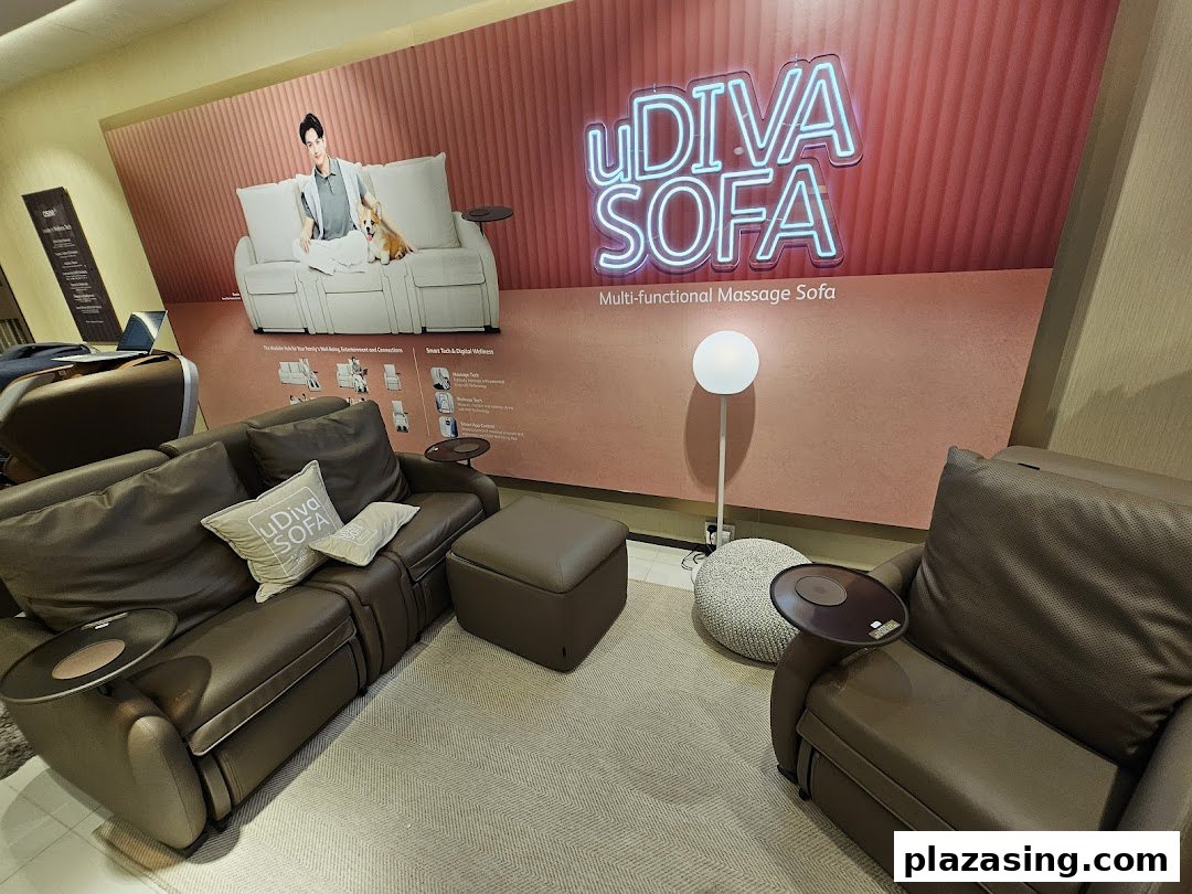 OSIM store interior showcasing brown uDiva massage sofas and a large promotional display.