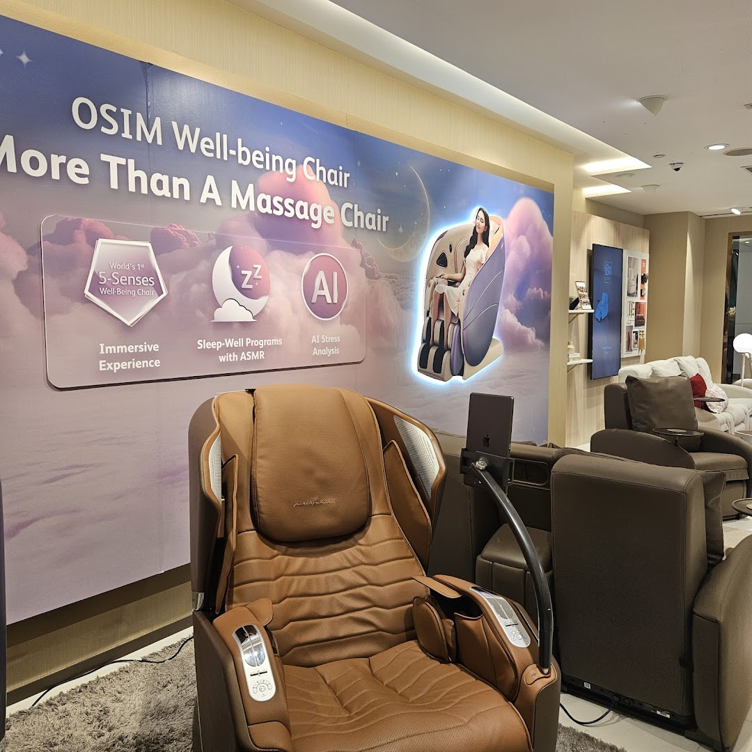 An OSIM store interior showcasing a brown massage chair and a promotional display for the 'Well-being Chair'.