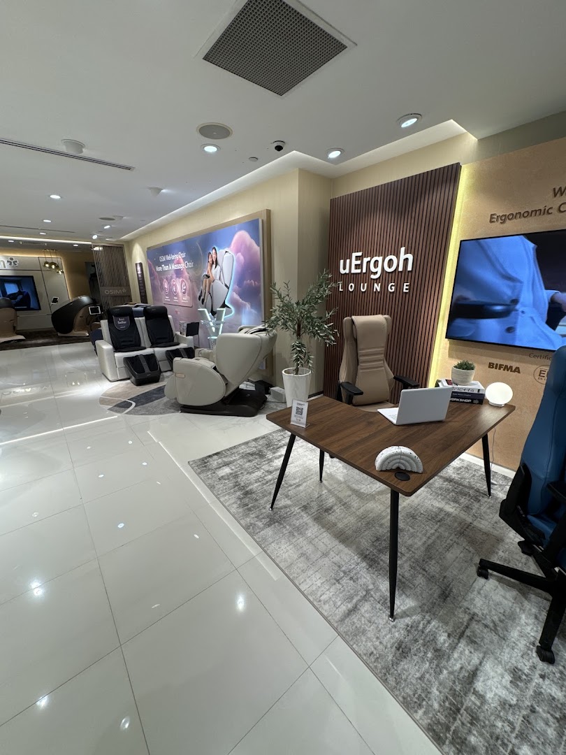Interior view of OSIM Plaza Singapura showcasing various massage chairs and ergonomic furniture in a modern showroom.