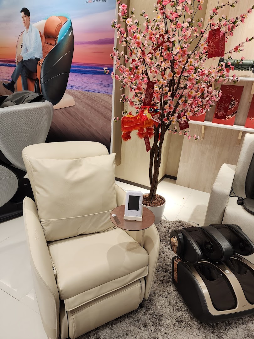 An OSIM store interior featuring a massage chair, foot massager, and festive cherry blossom decor.