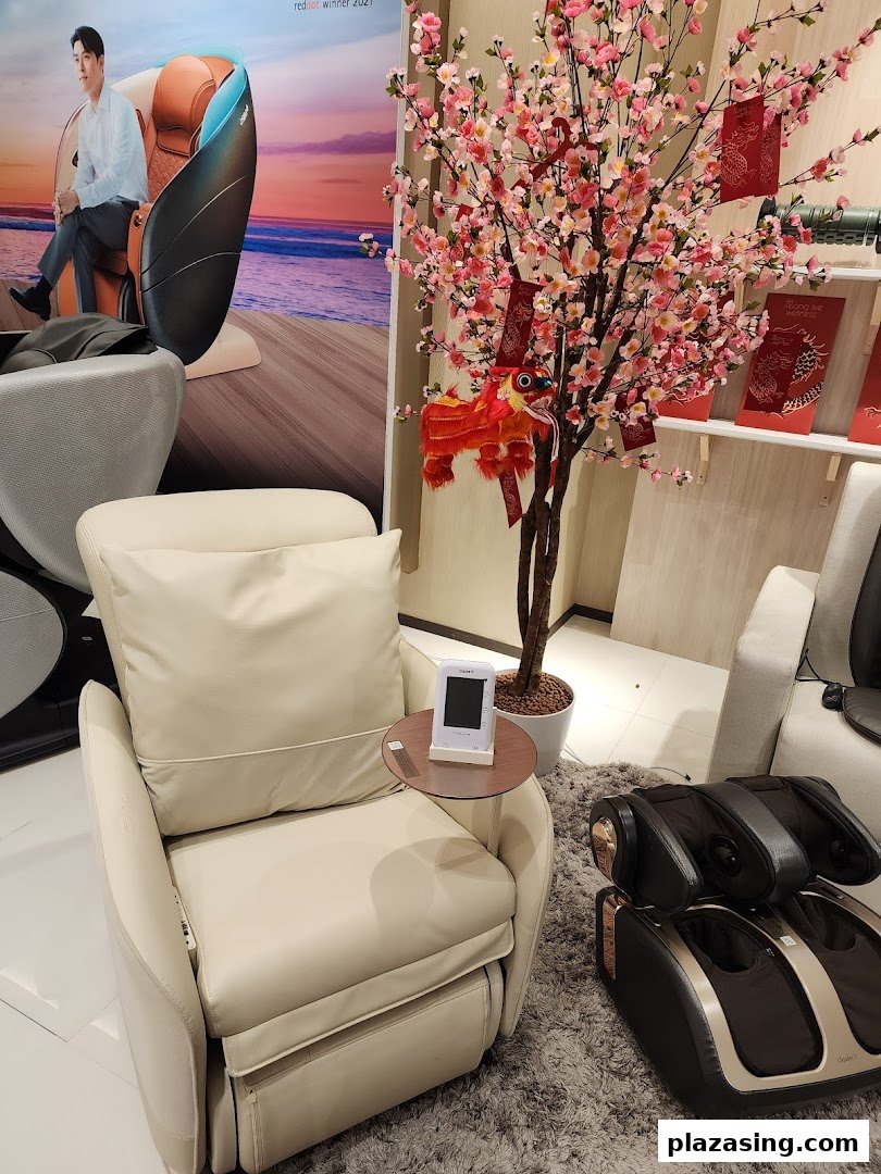 An OSIM store interior featuring a massage chair, foot massager, and festive cherry blossom decor.