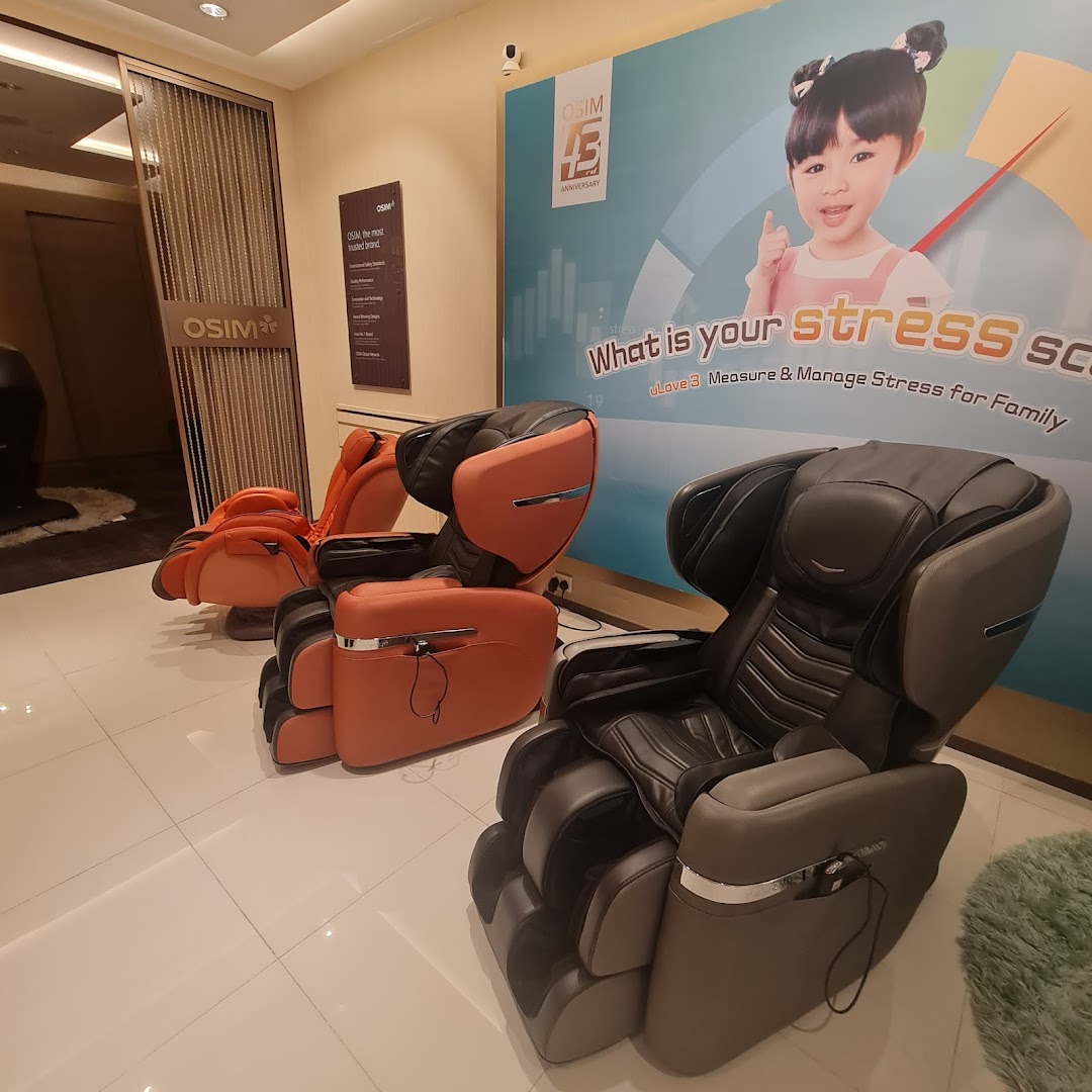 Interior view of OSIM showroom featuring various massage chairs and a large promotional banner.