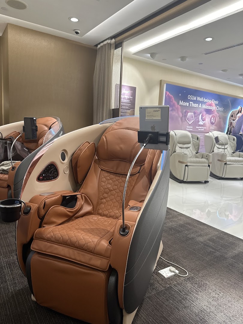 An interior view of OSIM showcasing luxurious massage chairs with interactive tablets.