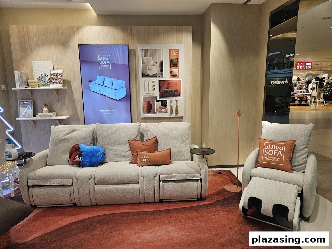 An OSIM display featuring the uDiva SOFA, a modular massage sofa, and a matching massage chair in a mall setting.