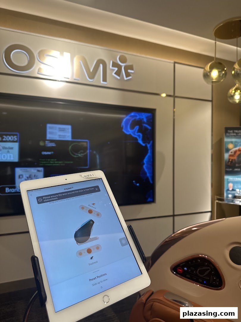 An OSIM massage chair with a control tablet displaying adjustment options in the store.