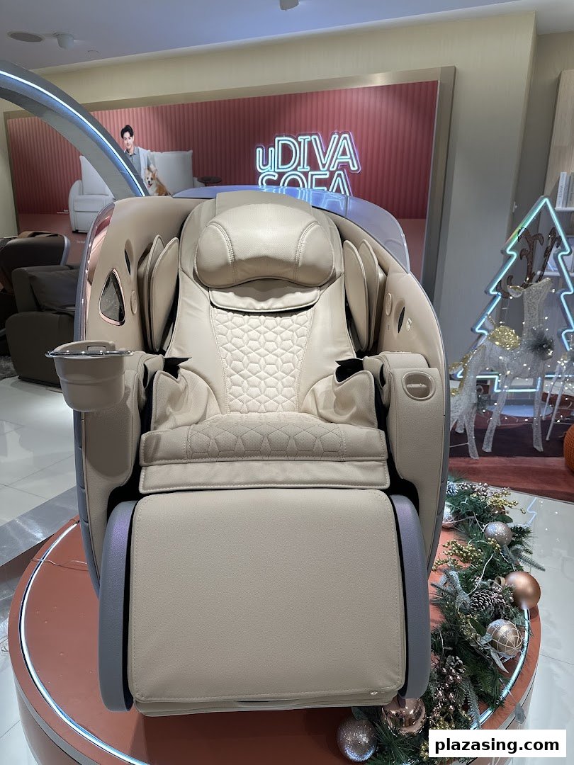 A luxurious beige massage chair displayed in an OSIM store, surrounded by festive decorations.