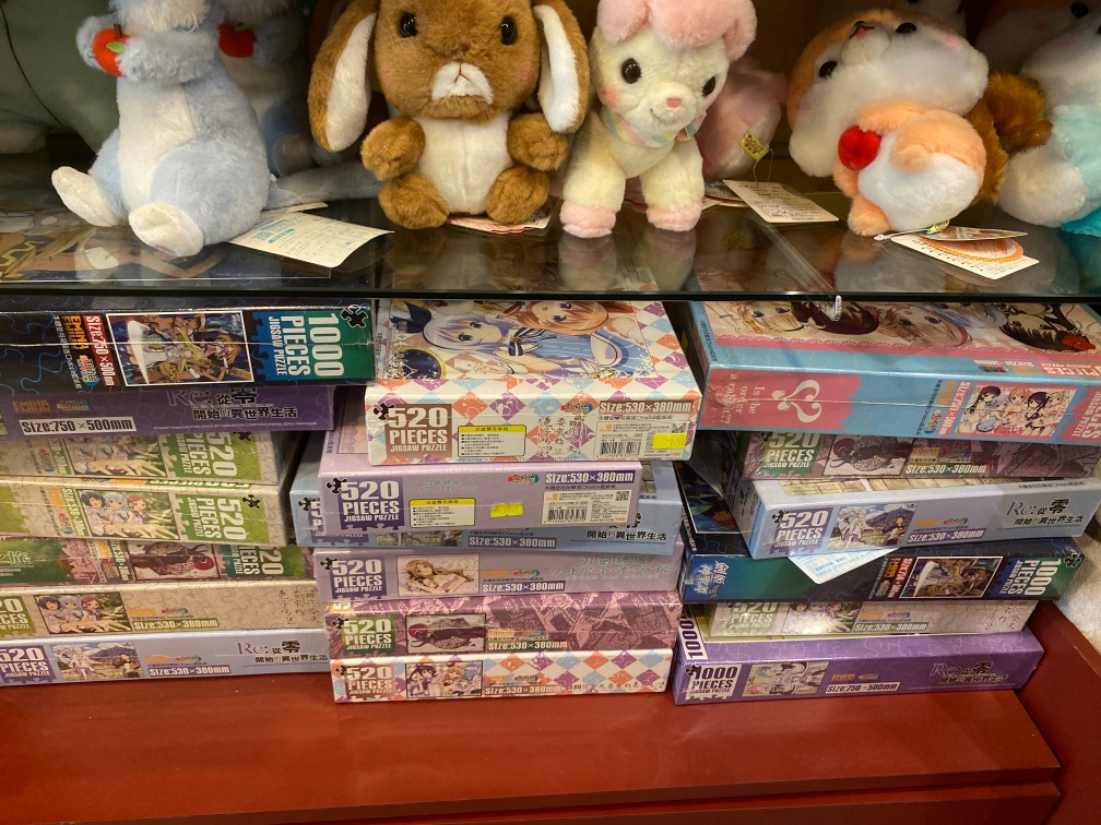 A display of anime-themed jigsaw puzzles and plush toys inside Otaku House.