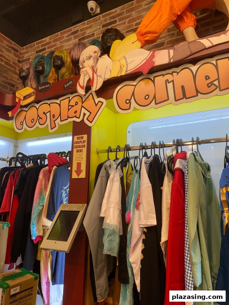 Interior view of Otaku House's cosplay corner featuring costumes, wigs, and anime decor.