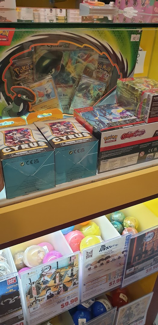 A vibrant display of Pokémon trading card game products and anime capsule toys.