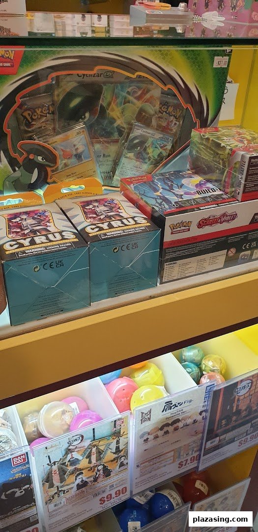 A vibrant display of Pokémon trading card game products and anime capsule toys.