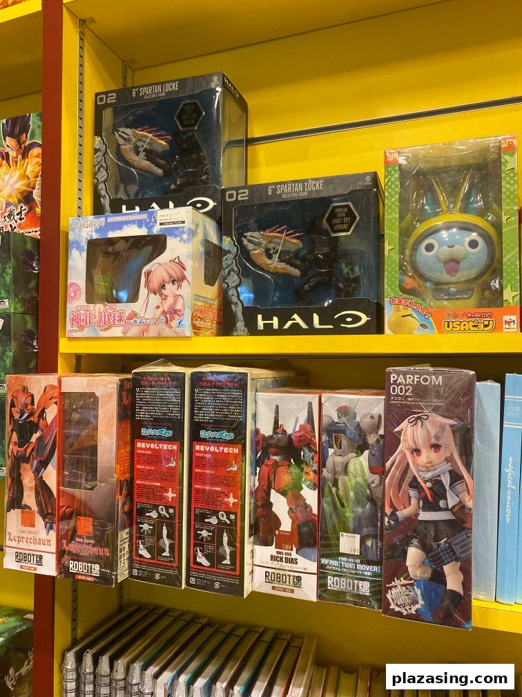 Shelves displaying a variety of anime figures, robot models, and collectible toys at Otaku House.