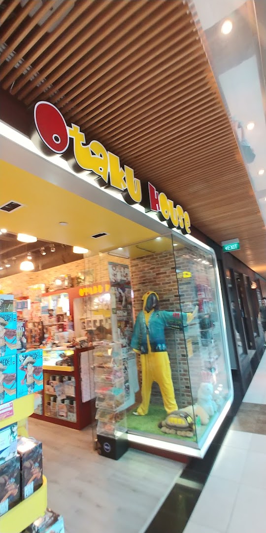 The storefront of Otaku House featuring a display window with a character costume.