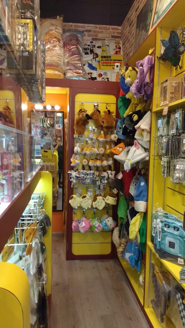 An interior view of Otaku House, showcasing shelves filled with anime plushies, character hats, and various merchandise.