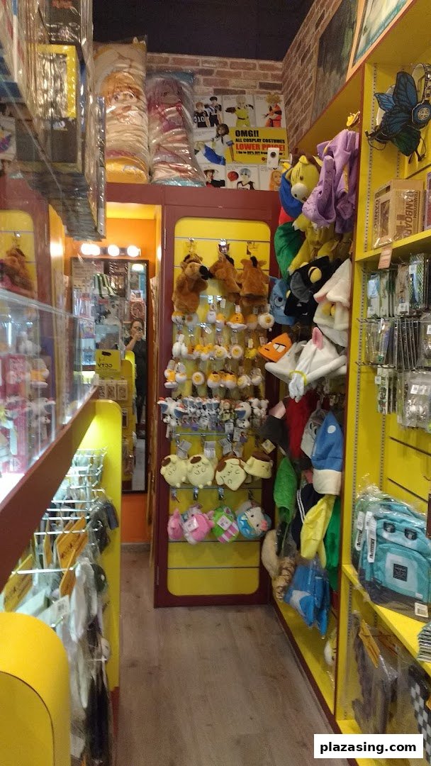 An interior view of Otaku House, showcasing shelves filled with anime plushies, character hats, and various merchandise.
