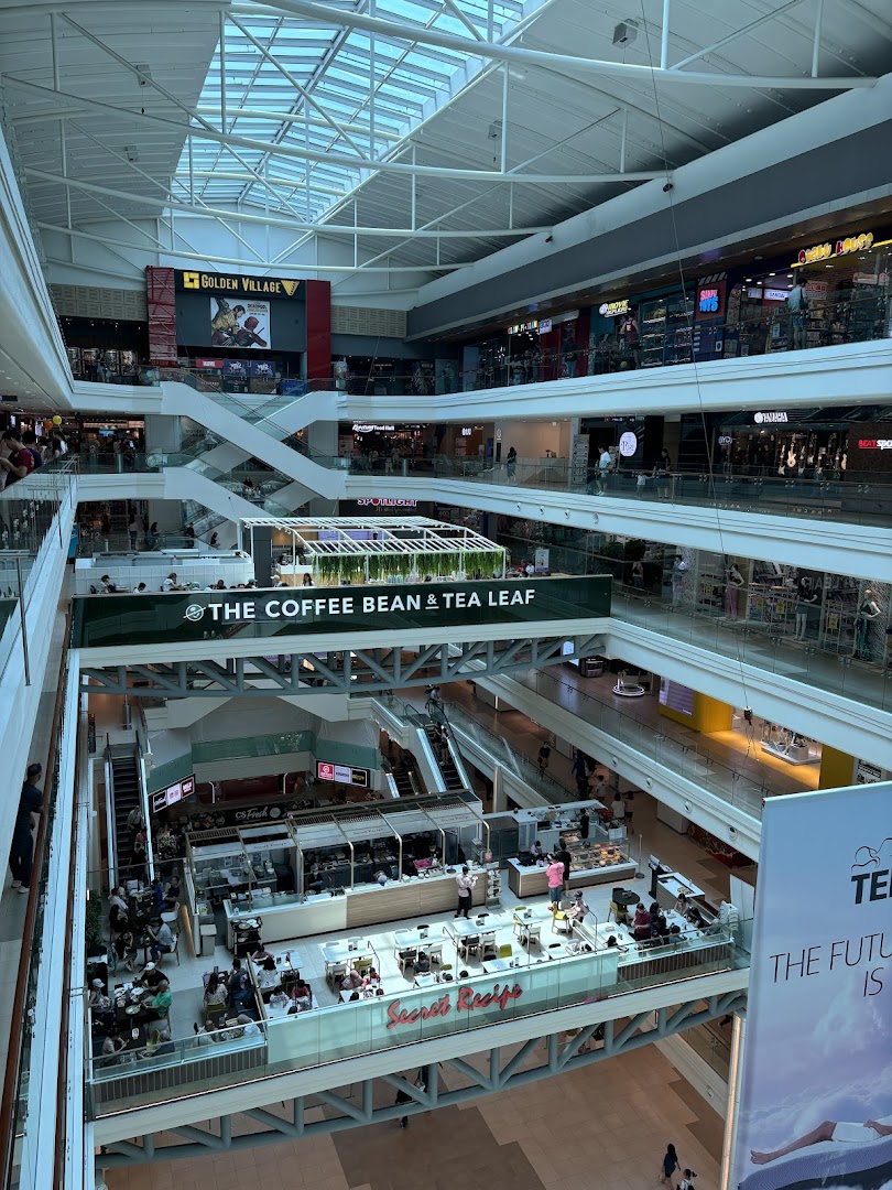An expansive view of Plaza Singapura's multi-level interior, showcasing various retail outlets and dining areas.
