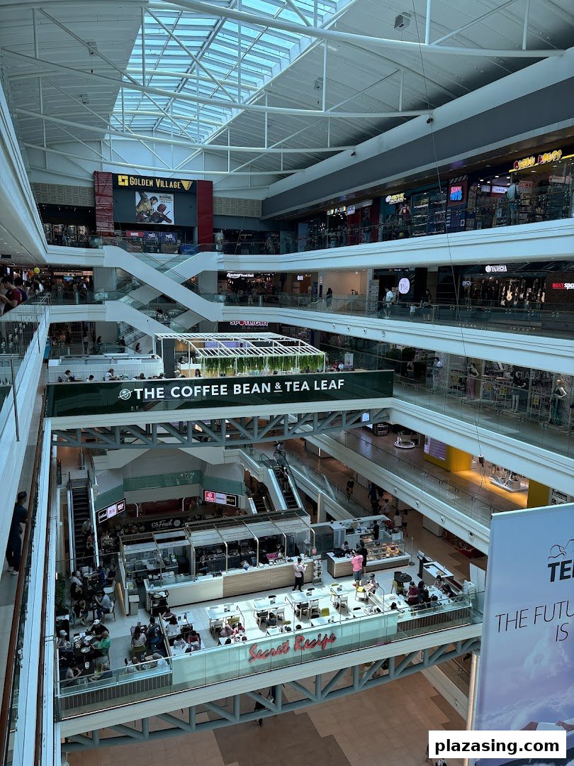 An expansive view of Plaza Singapura's multi-level interior, showcasing various retail outlets and dining areas.