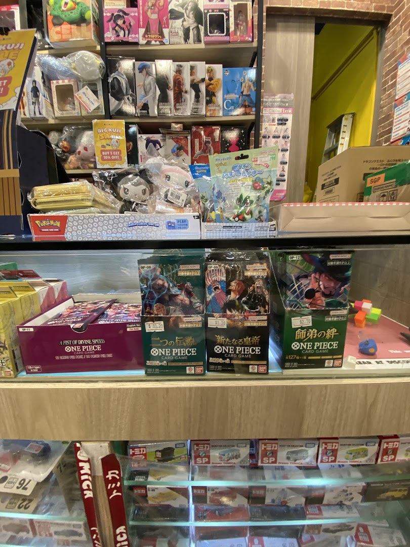 Shelves filled with anime figures, One Piece card games, Pokemon merchandise, and Tomica toy cars.
