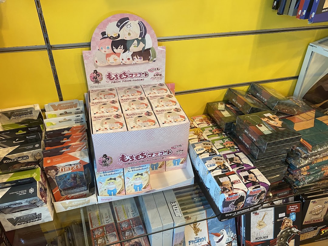 A vibrant display of anime and pop culture merchandise, featuring Mochi Mochi Mascots, Vanguard cards, and other collectibles.