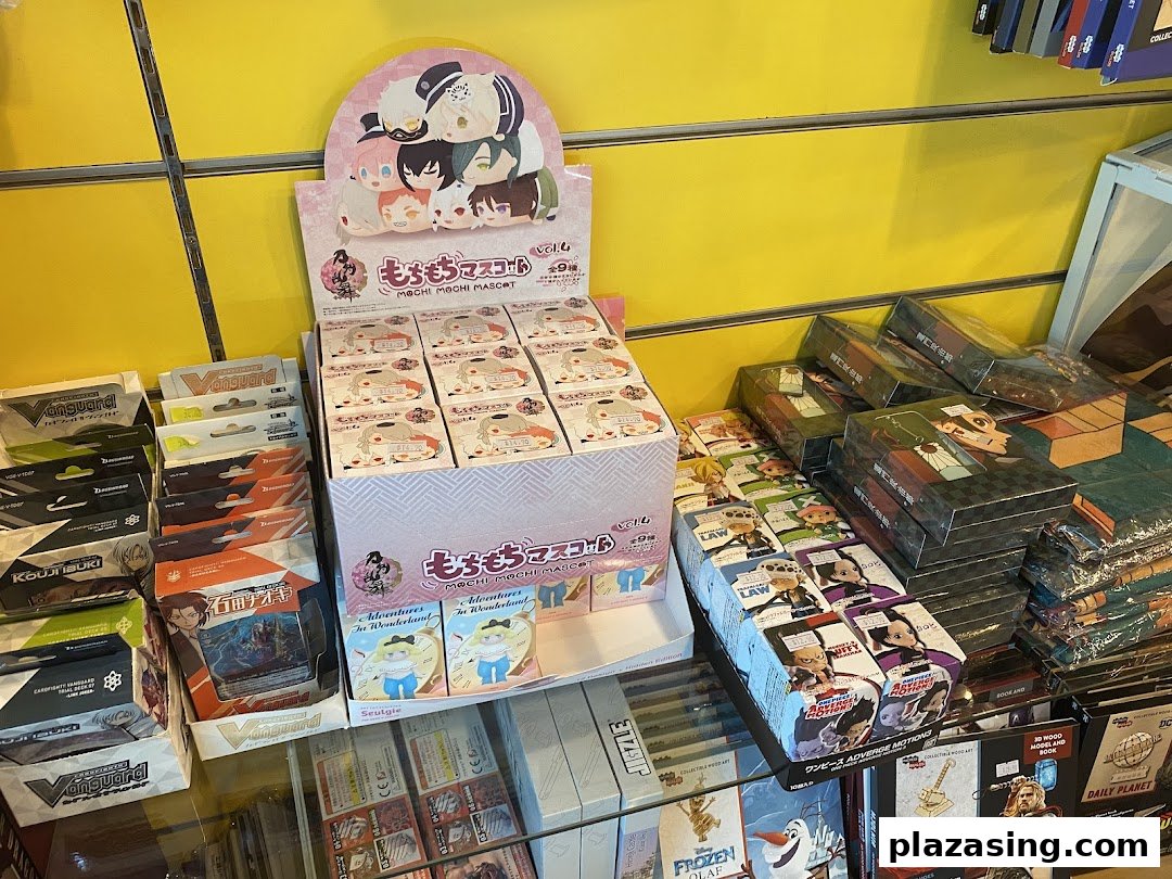 A vibrant display of anime and pop culture merchandise, featuring Mochi Mochi Mascots, Vanguard cards, and other collectibles.