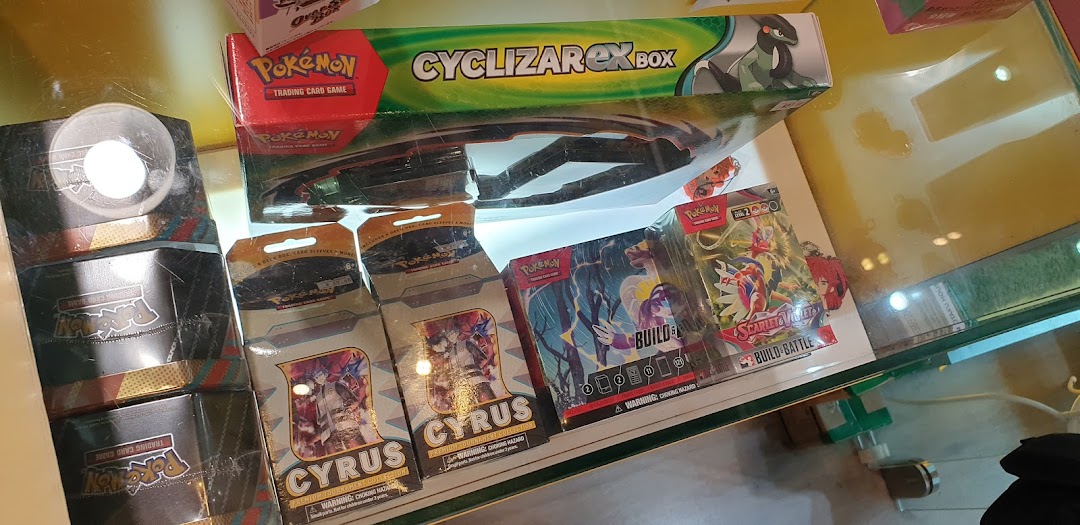 A display case filled with Pokémon Trading Card Game products and other card game items.