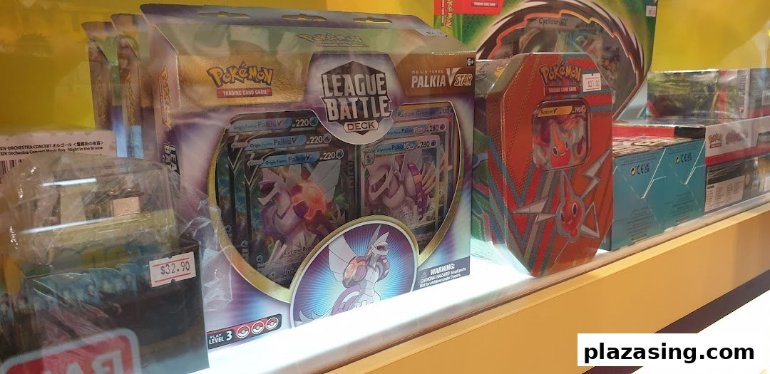 A display case filled with various Pokémon Trading Card Game products, including League Battle Decks and tins.