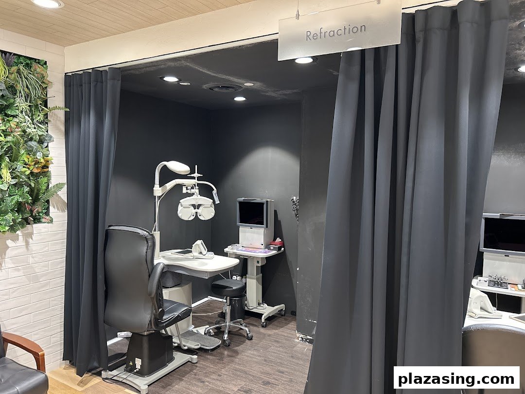 An eye examination room at OWNDAYS, featuring a phoropter, chair, and privacy curtains for refraction.