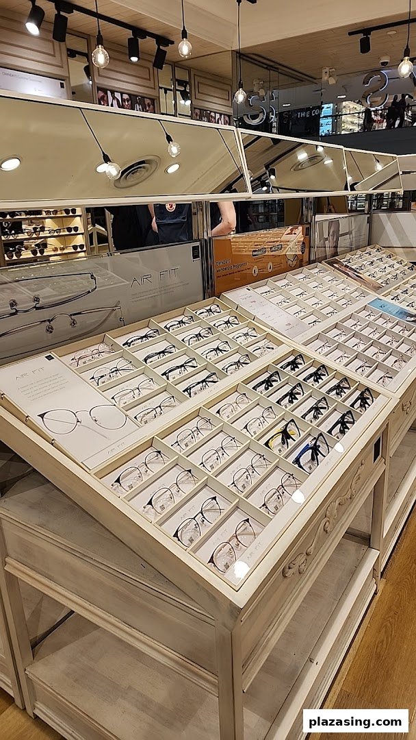 Interior view of OWNDAYS, showcasing multiple display cases filled with a wide selection of eyeglasses.